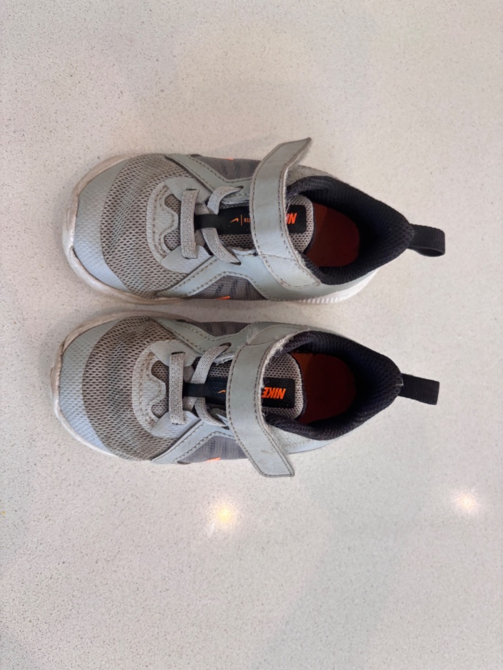 Nike 6C athletic shoes in grey and orange.